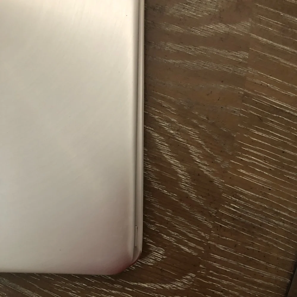 ASUS Metallic Silver Convertible Laptop with a wireless mouse and a charger.